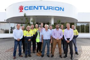 Centurion CEO Justin Cardaci, second from right at front, and the company’s Executive General Manager East Coast, Keith Price (centre) with the company’s Brisbane team at their Rocklea depot.